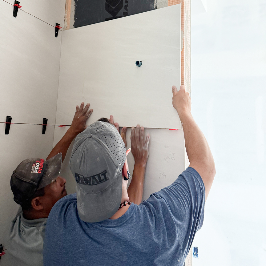 Professional installer fitting material to wall