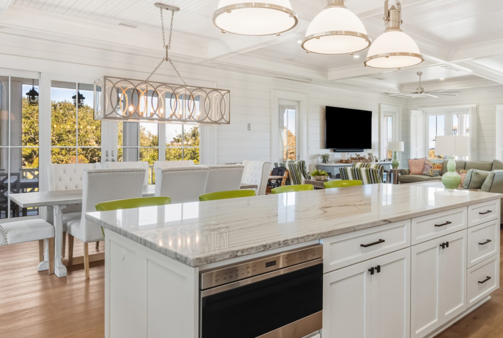 Modern kitchen with wood flooring and white cabinetry