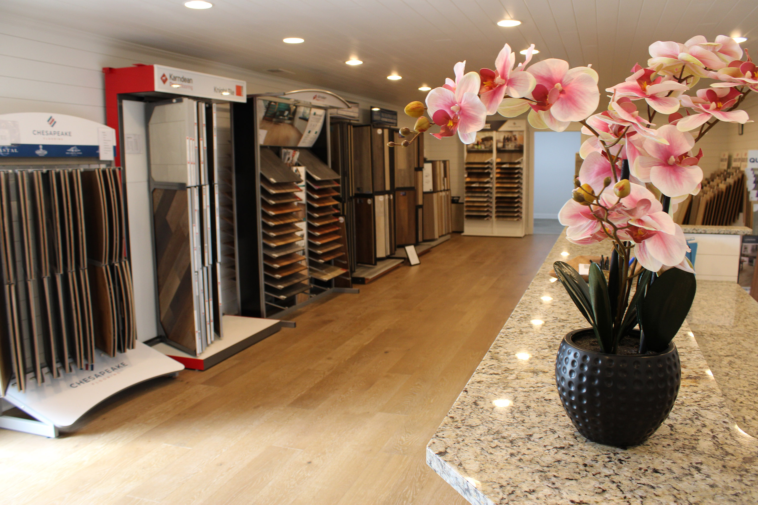 J&S Flooring showroom interior with flooring samples and decorative flowers