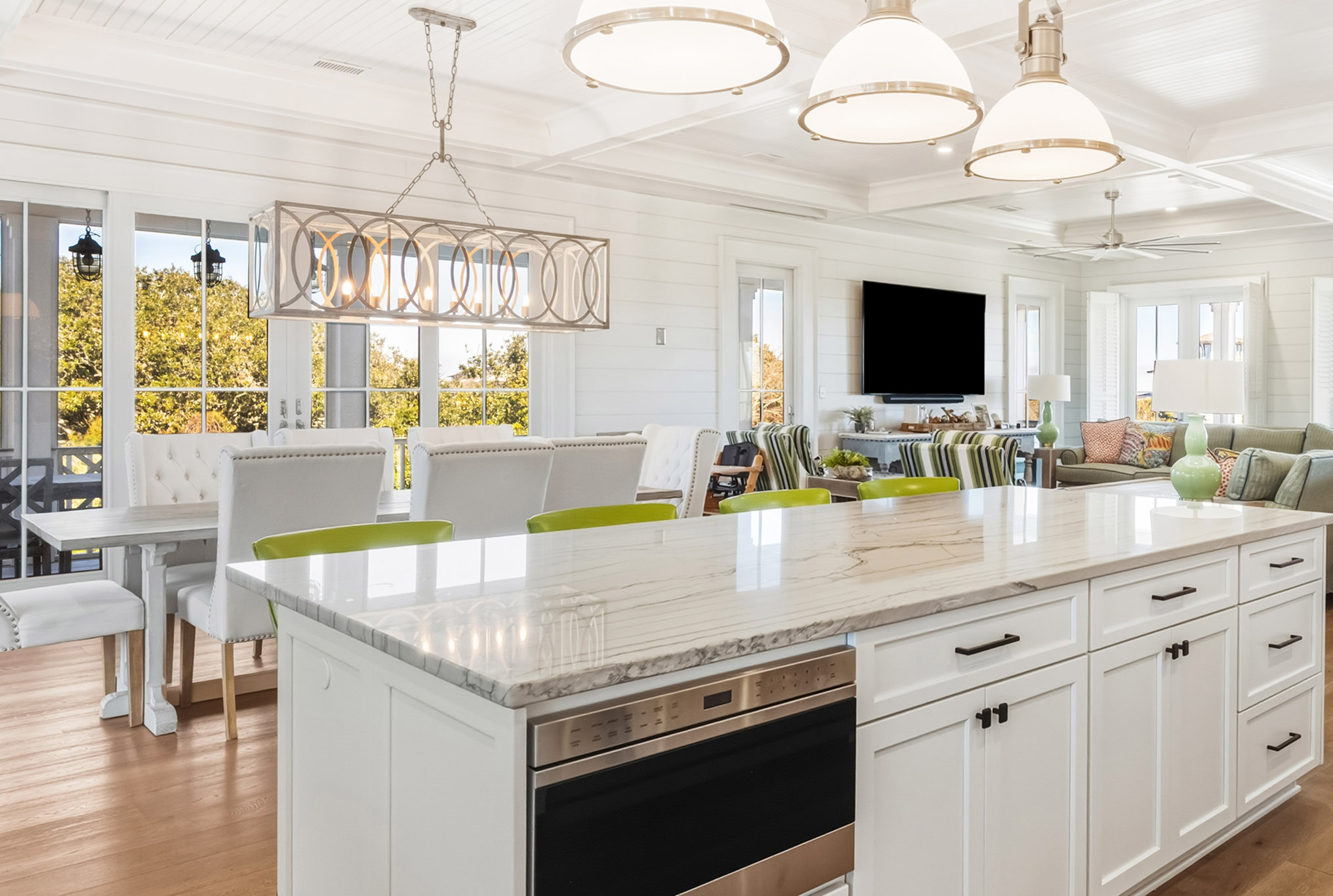 Modern kitchen with wood flooring and white cabinetry