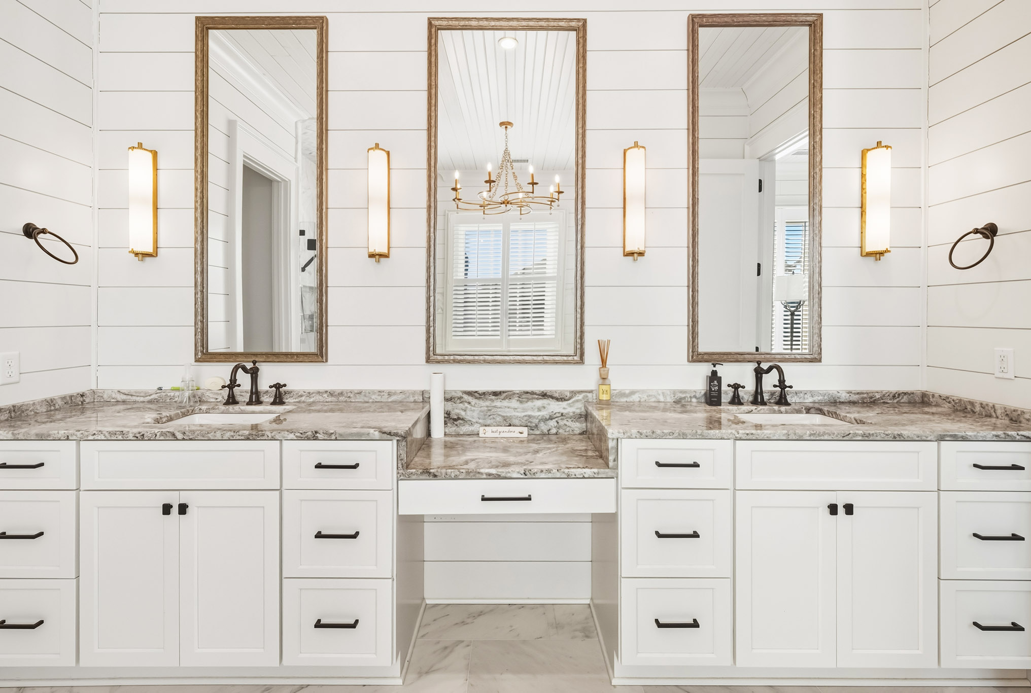 Custom residential bathroom vanity with white cabinetry