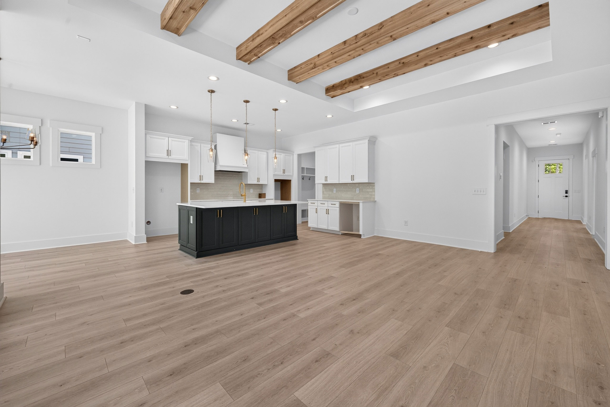 Overview photo of a production home living space with flooring the kitchen, living space and dining areas